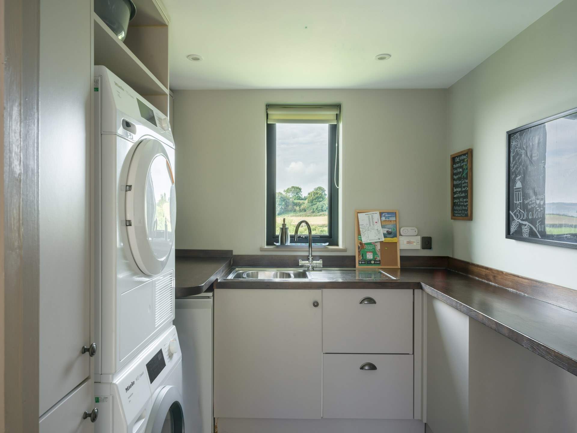 The ever useful separate utility-room has a washing machine and tumble-drier.