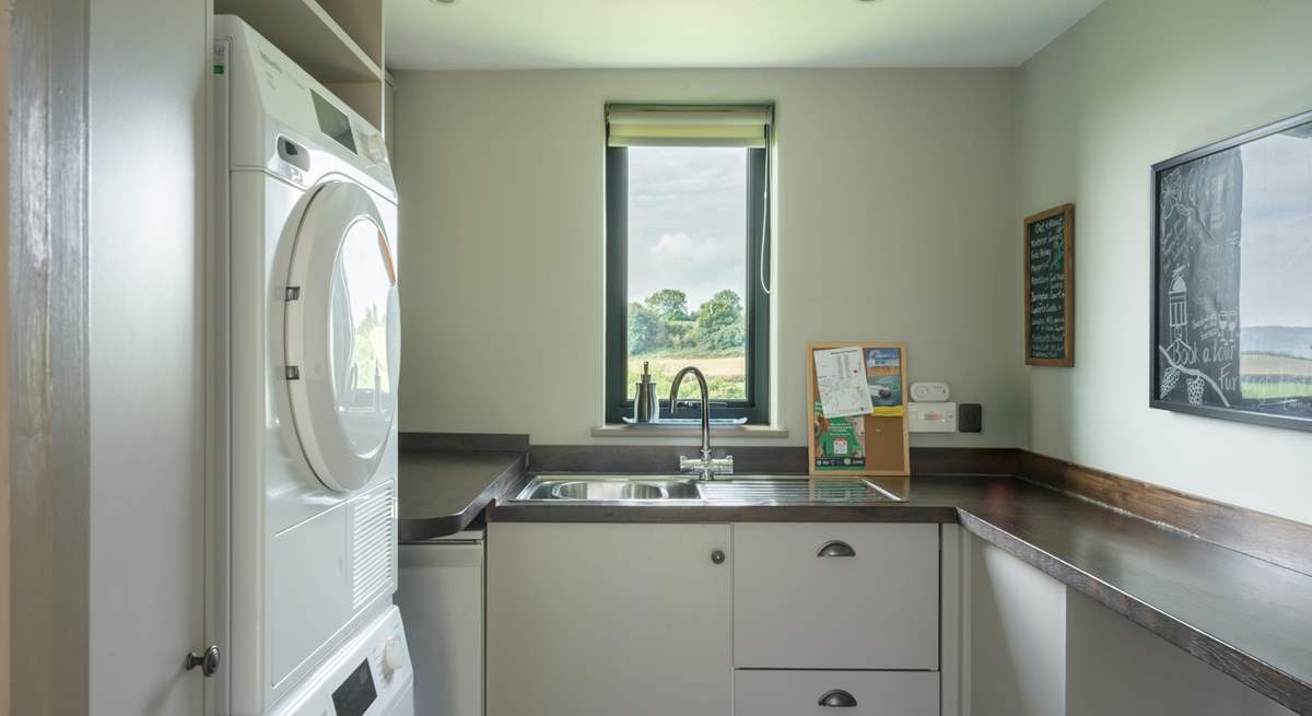 The ever useful separate utility-room has a washing machine and tumble-drier.