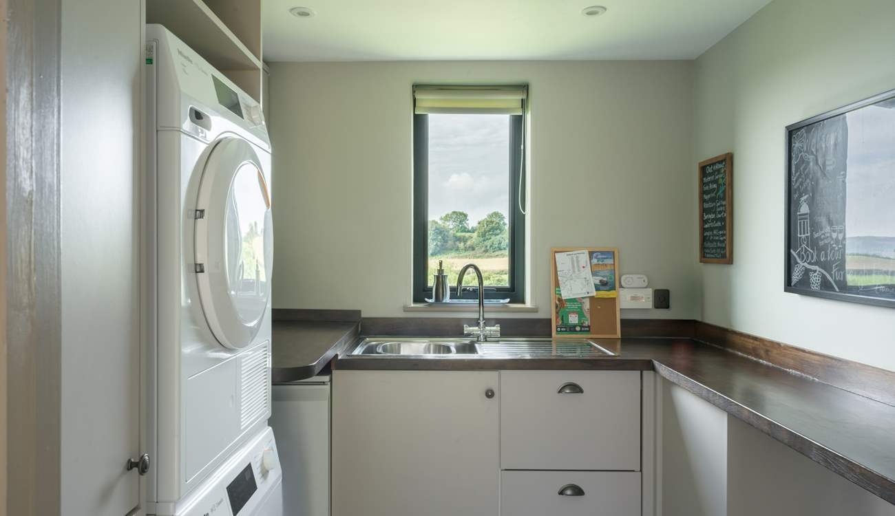 The ever useful separate utility-room has a washing machine and tumble-drier.