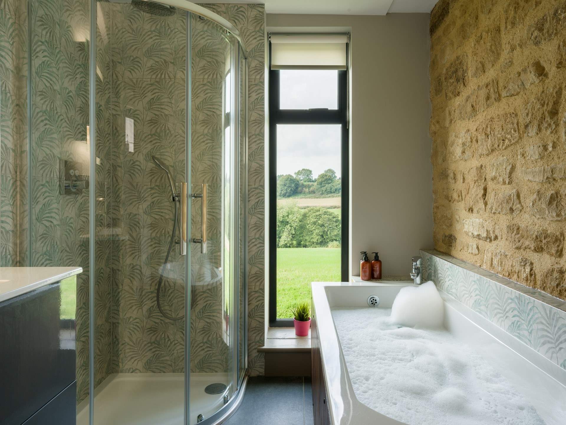 The main bathroom has the perfect mix of rustic and contemporary styling and it would be fair to say that the bath has quite the view.