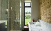 The main bathroom has the perfect mix of rustic and contemporary styling and it would be fair to say that the bath has quite the view. - Thumbnail Image