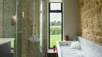 The main bathroom has the perfect mix of rustic and contemporary styling and it would be fair to say that the bath has quite the view.