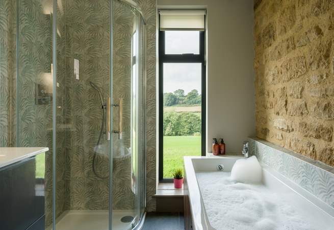 The main bathroom has the perfect mix of rustic and contemporary styling and it would be fair to say that the bath has quite the view.