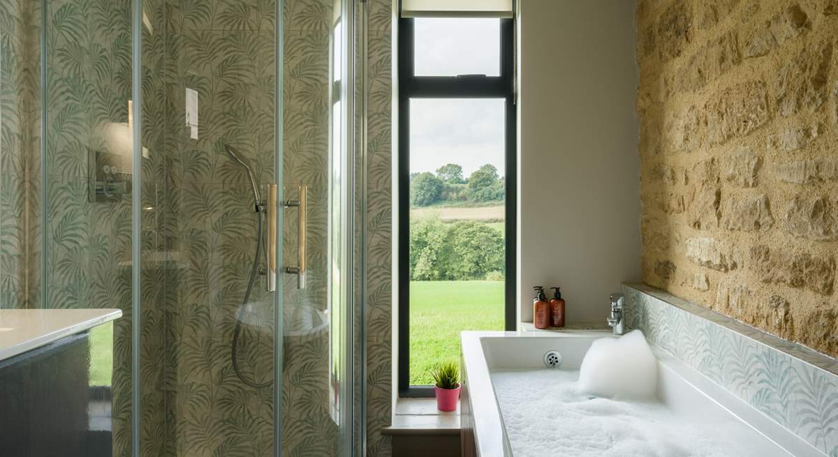 The main bathroom has the perfect mix of rustic and contemporary styling and it would be fair to say that the bath has quite the view.