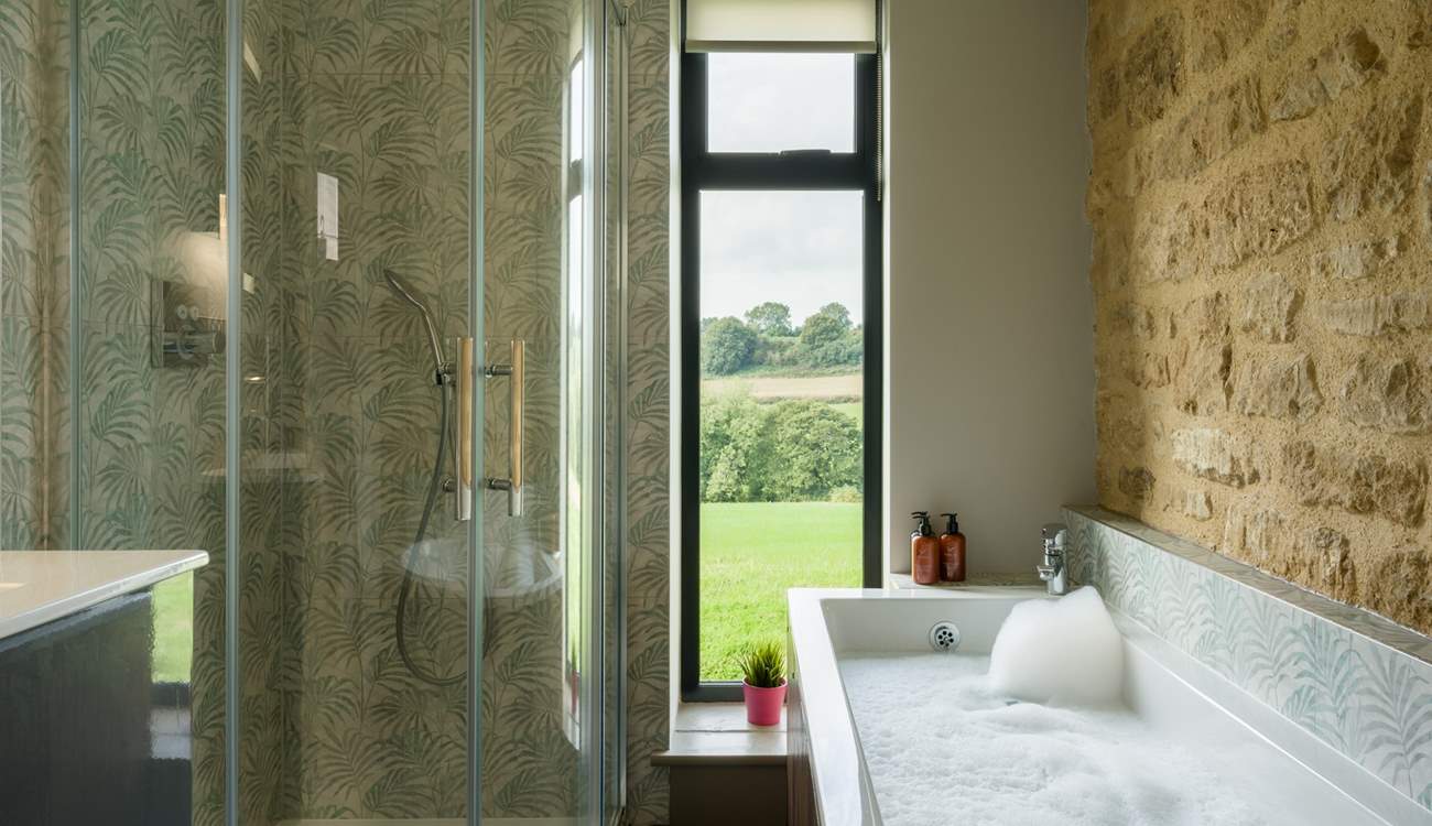 The main bathroom has the perfect mix of rustic and contemporary styling and it would be fair to say that the bath has quite the view.