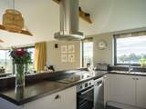 The designer kitchen is fully equipped and makes for a wonderful social dining environment
