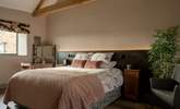 The primary bedroom is serene with a super-king size bed (can be split into two twins) and luxurious linen. - Thumbnail Image
