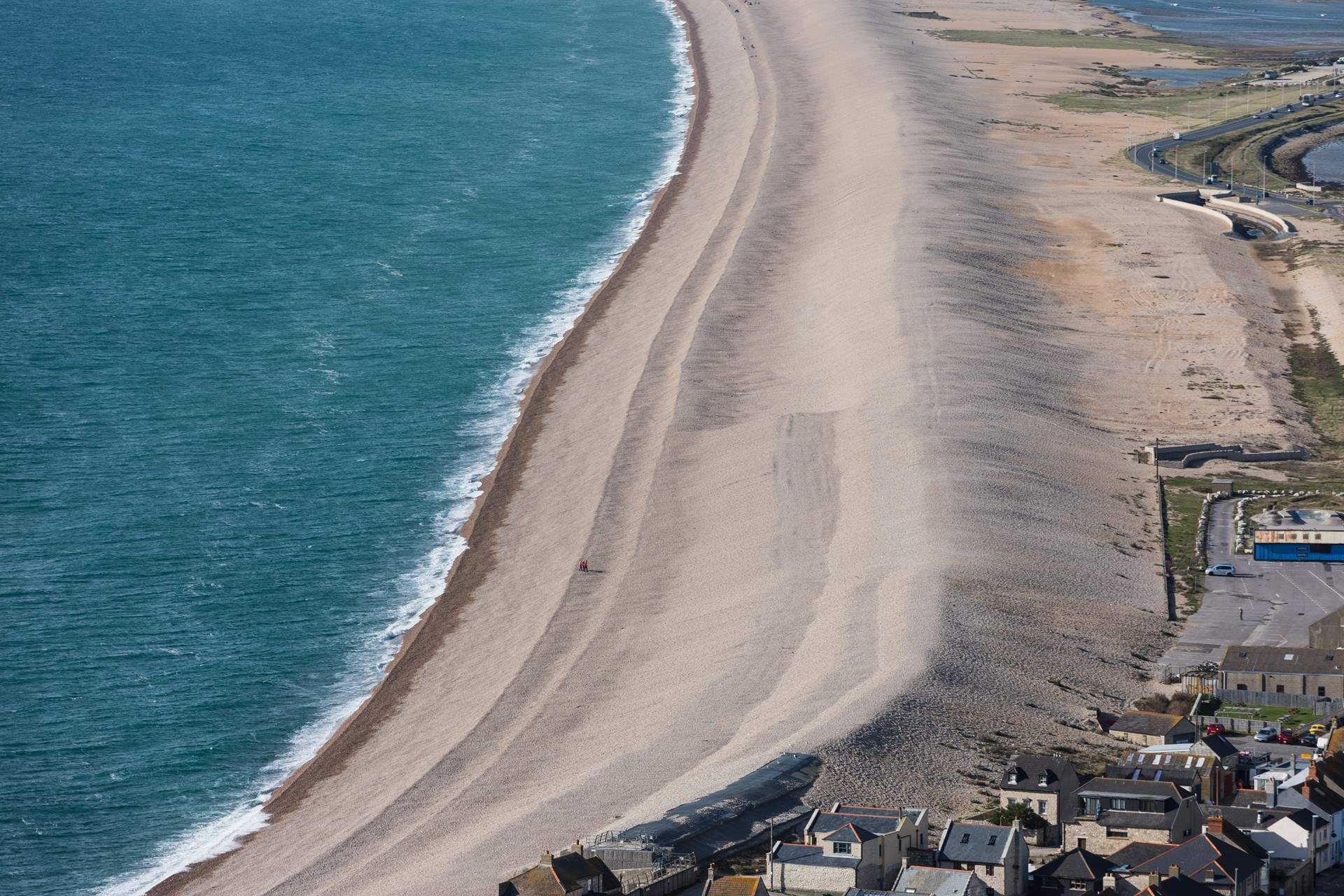 The striking Chesil Beach with Weymouth along the bay.