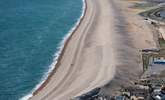 The striking Chesil Beach with Weymouth along the bay. - Thumbnail Image