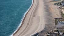 The striking Chesil Beach with Weymouth along the bay.