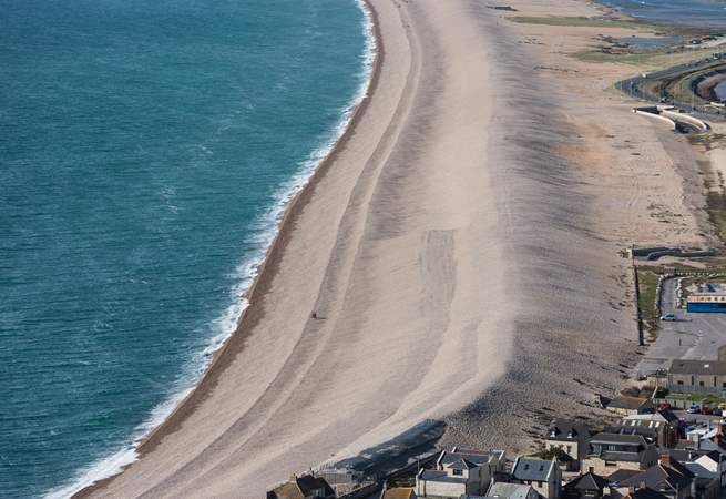 The striking Chesil Beach with Weymouth along the bay.