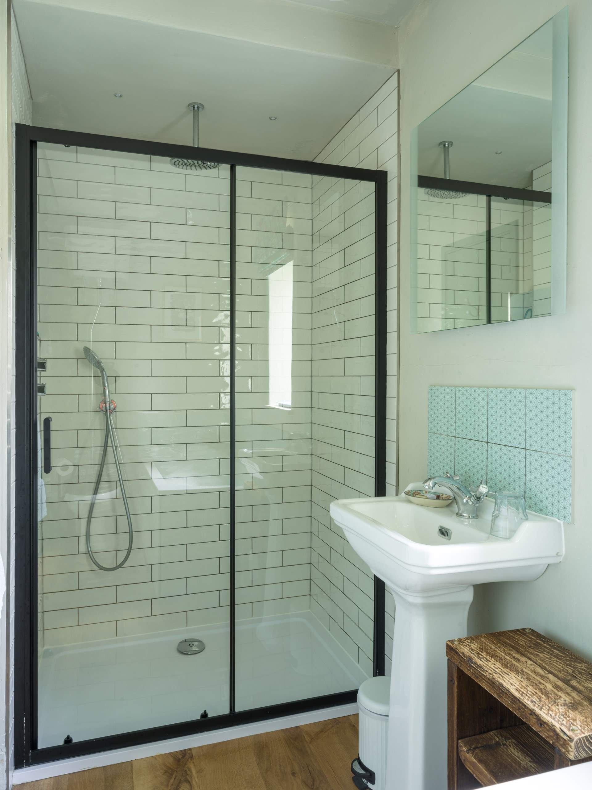 The bathroom is very spacious with a large shower enclosure and rainfall shower.