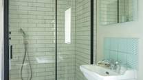 The bathroom is very spacious with a large shower enclosure and rainfall shower.