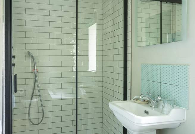 The bathroom is very spacious with a large shower enclosure and rainfall shower.