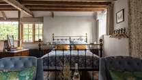 The king-size bed is beautifully presented with luxurious linens. You will sleep well here. Just to note that the bed has been altered by 90 degrees to provide even more space and light.