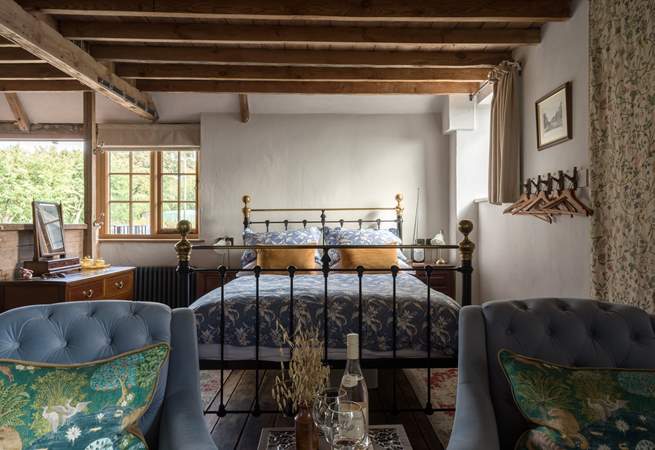 The king-size bed is beautifully presented with luxurious linens. You will sleep well here.