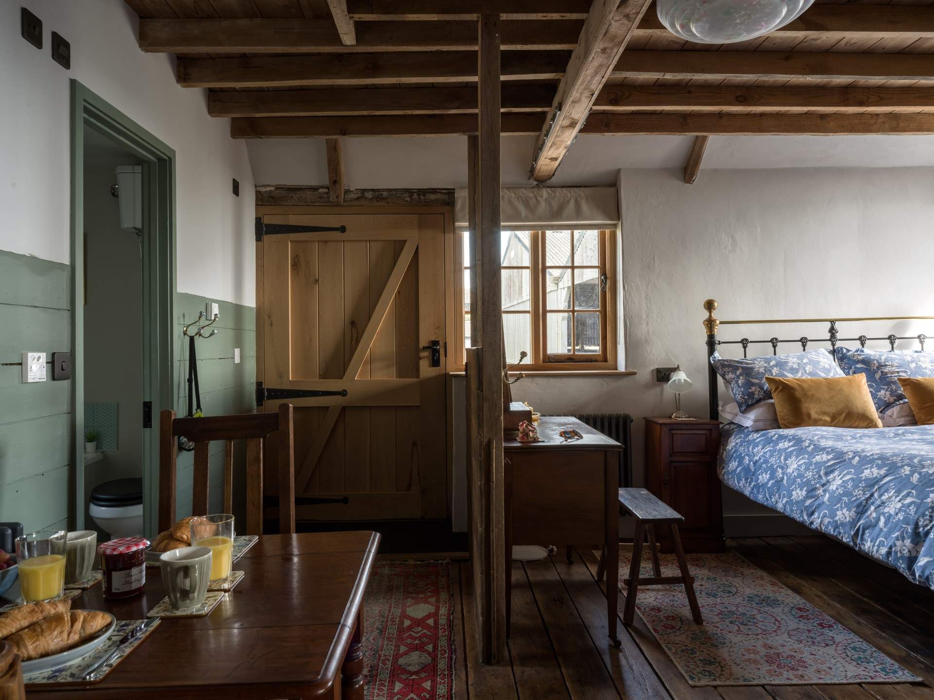 So much of the original character and features are still on show. To the left of the living space is the luxury bathroom.