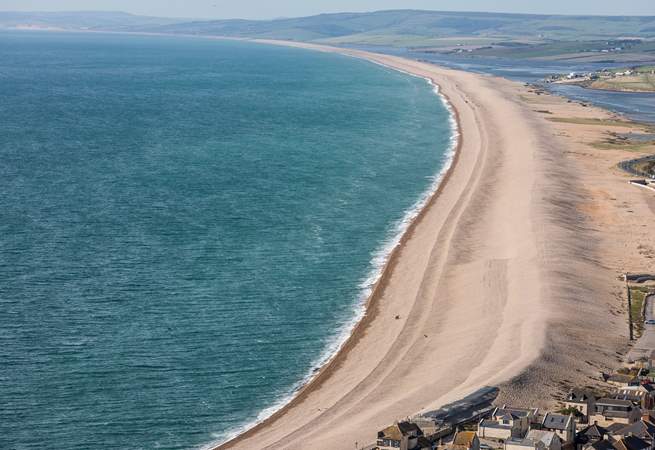 The striking Chesil Beach with Weymouth just around the bay.
