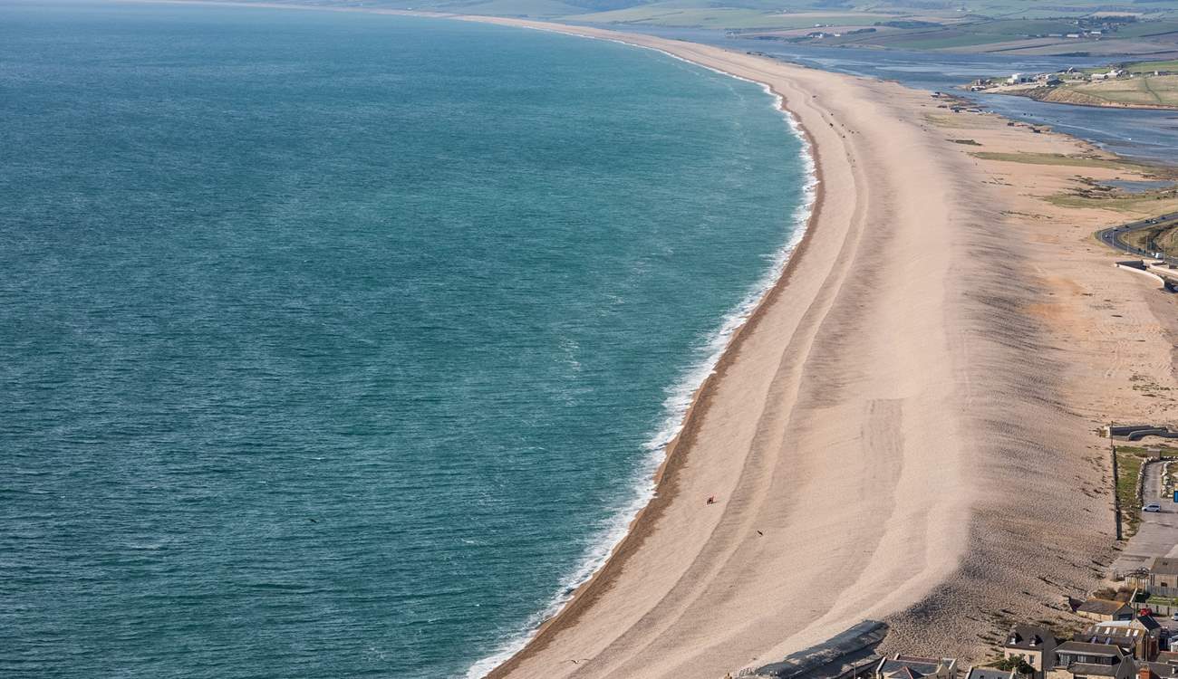 The striking Chesil Beach with Weymouth just around the bay.