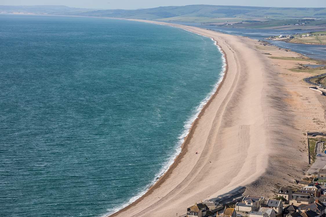 The striking Chesil Beach with Weymouth just around the bay.