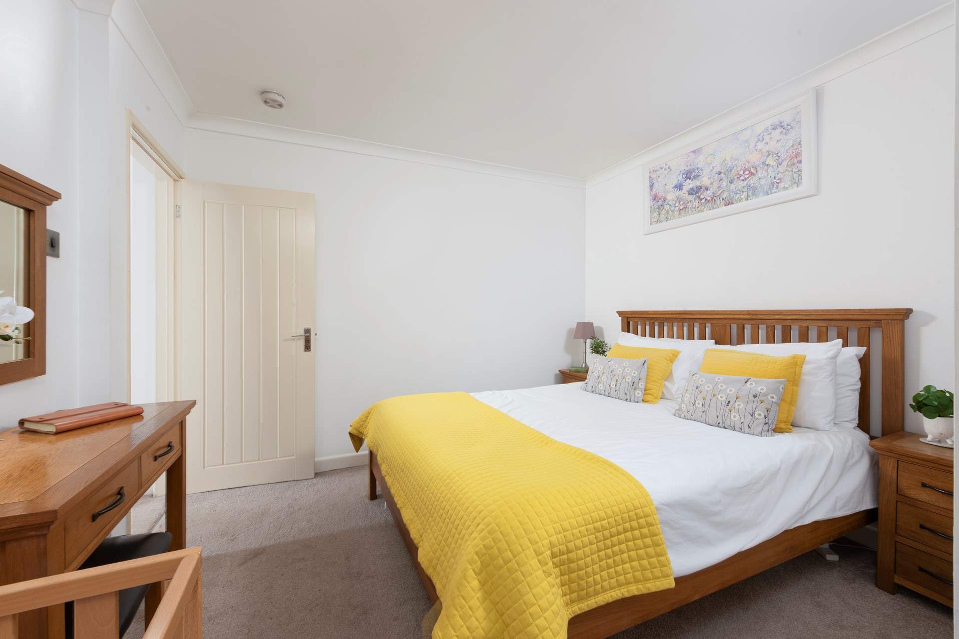 The en suite king-size bedroom (bedroom 2) has a sunny disposition.