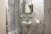 The sleek en suite to bedroom 2. Please note the shower door is narrow.