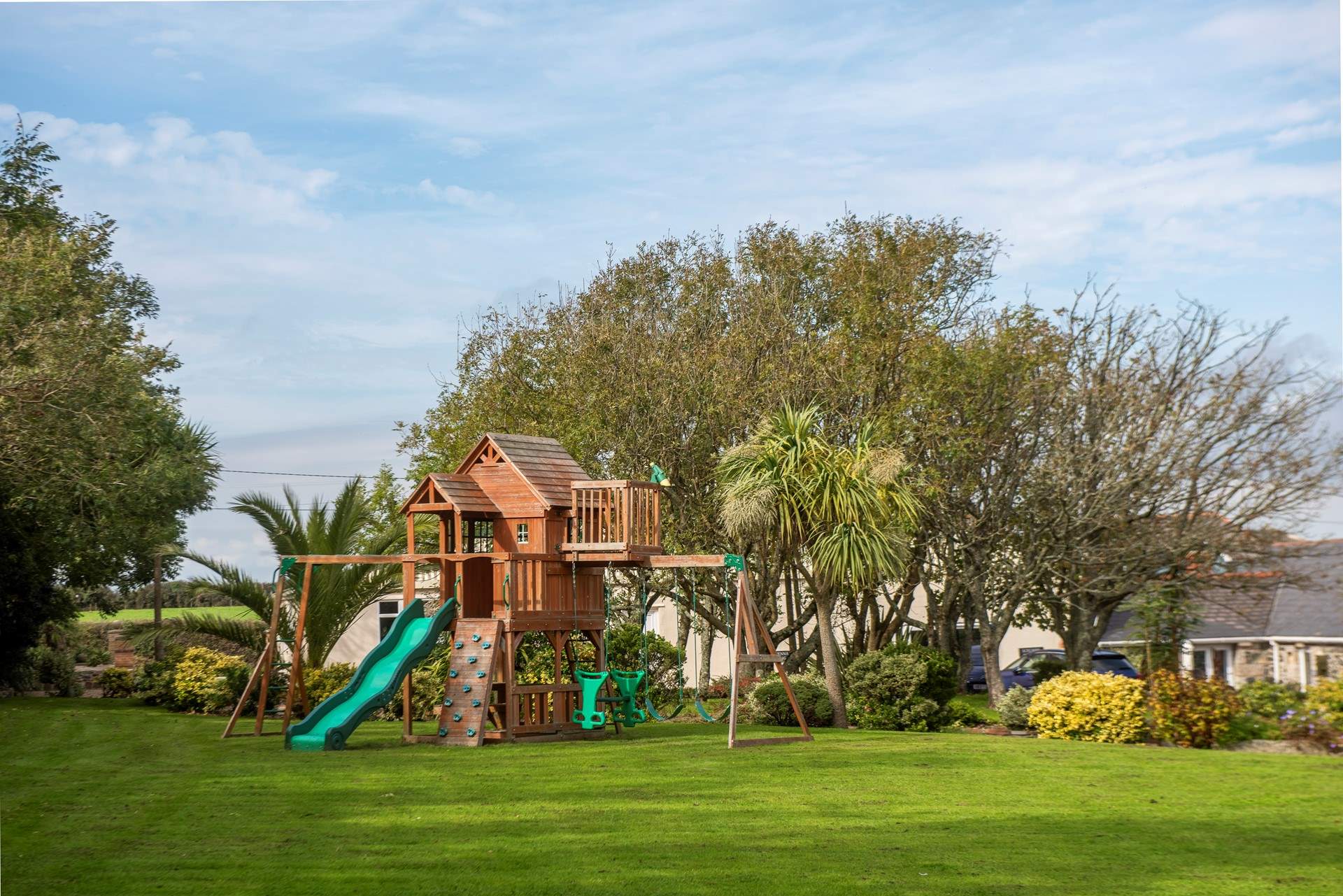 The playhouse is situated in an enormous and beautifully maintained lawn and garden area.