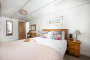This large king-size bedroom is perfectly appointed.