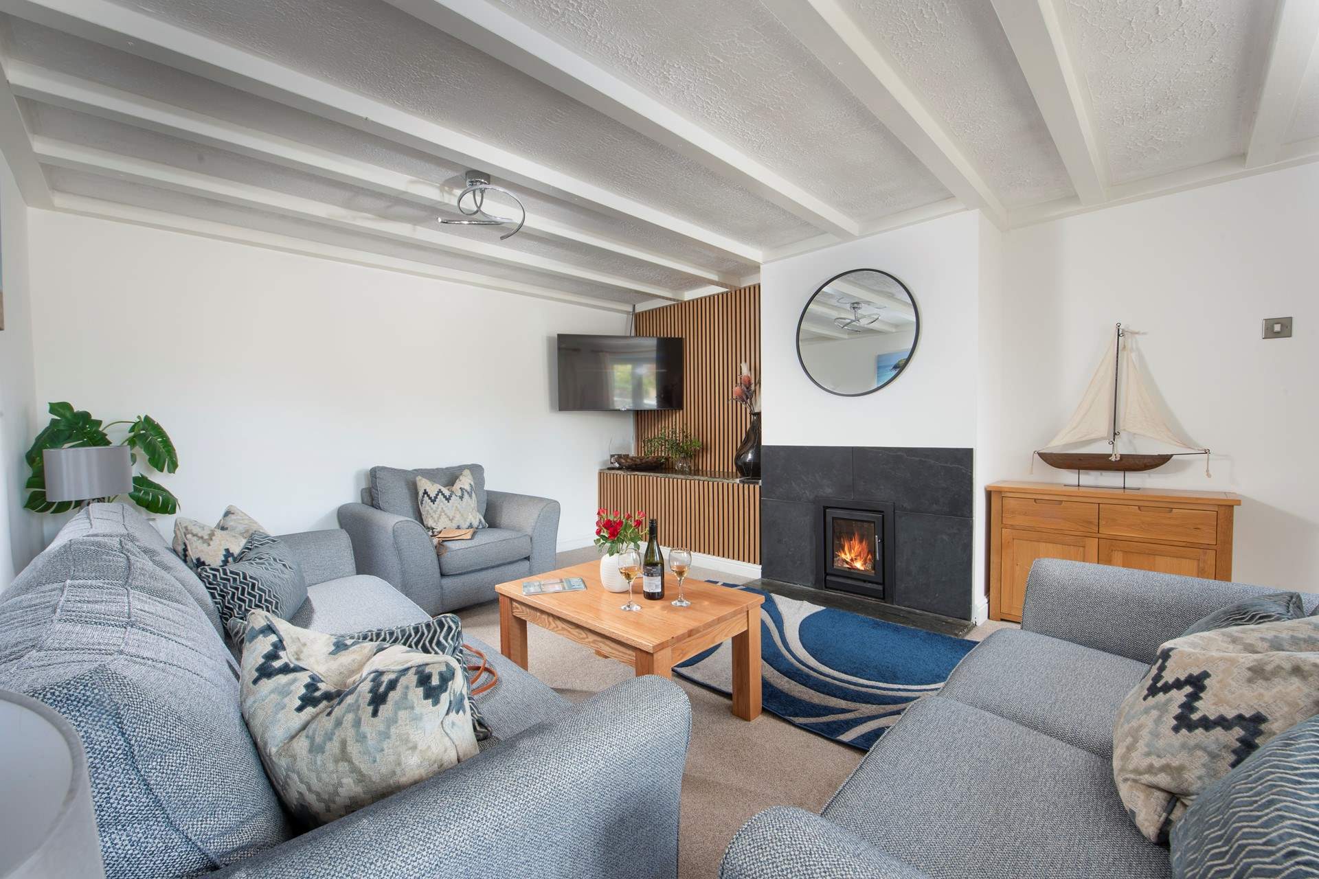 The sitting-room is comfortable yet stylish, complete with wood-burner.