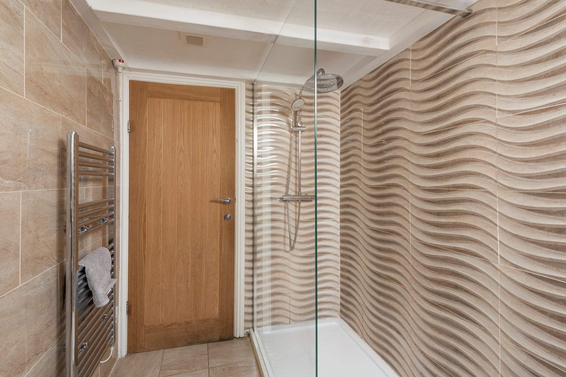 The sleek family shower-room is situated next door to the blue twin room.