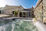 The hot tub is big enough for the whole party to enjoy.