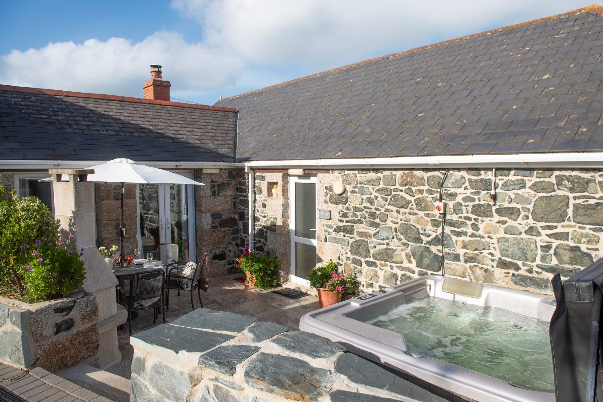 There are two steps down from the parking area to the patio.