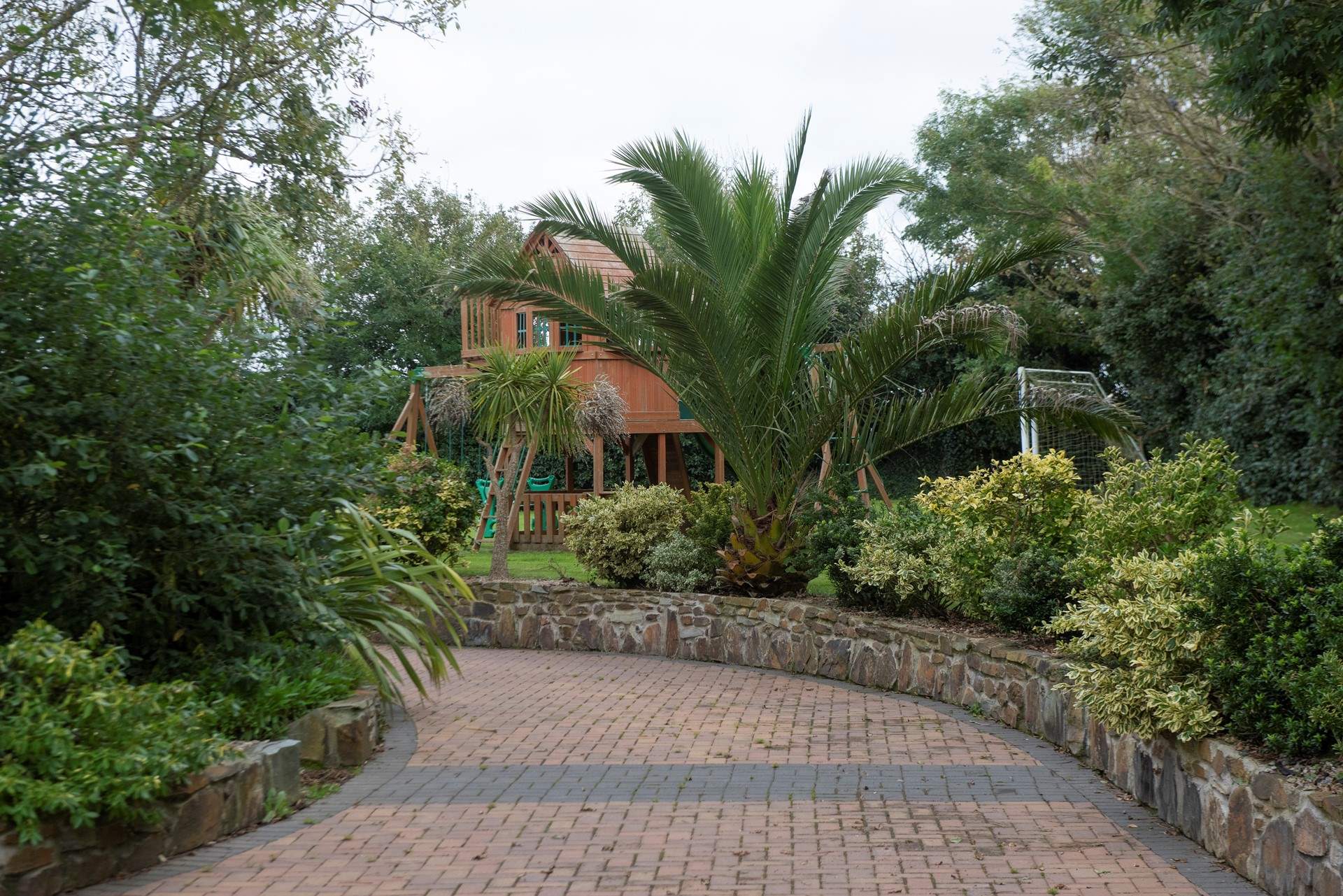 The well maintained driveway and gardens.