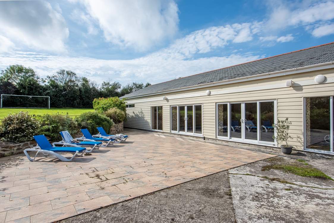 There is a sunny veranda for lounging, just outside the pool house.