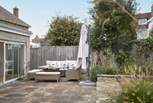 The patio area has lovely furniture for al fresco dining.