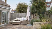 The patio area has lovely furniture for al fresco dining.