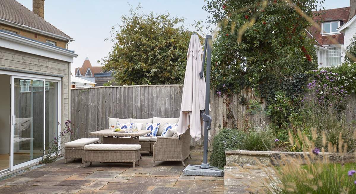 The patio area has lovely furniture for al fresco dining.