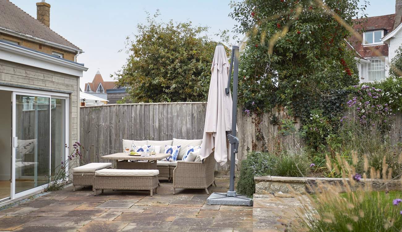 The patio area has lovely furniture for al fresco dining.