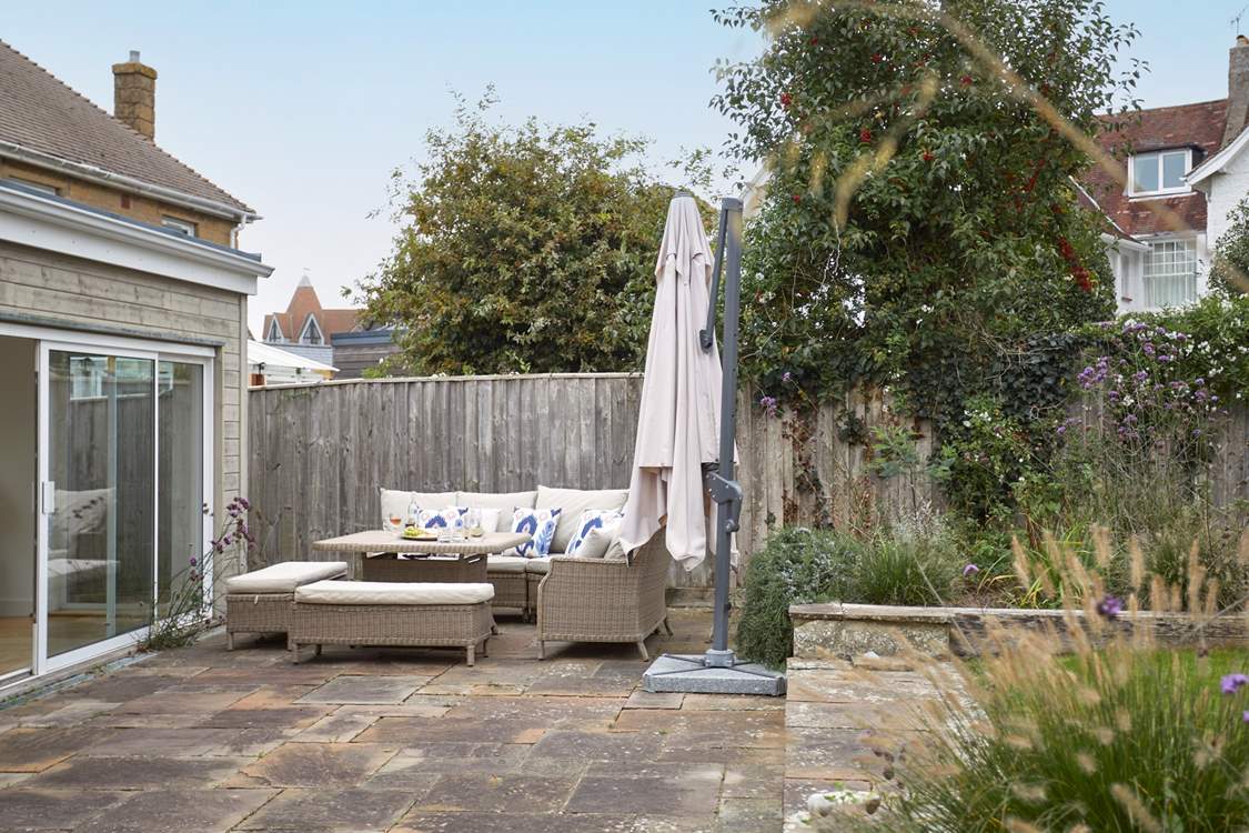 The patio area has lovely furniture for al fresco dining.