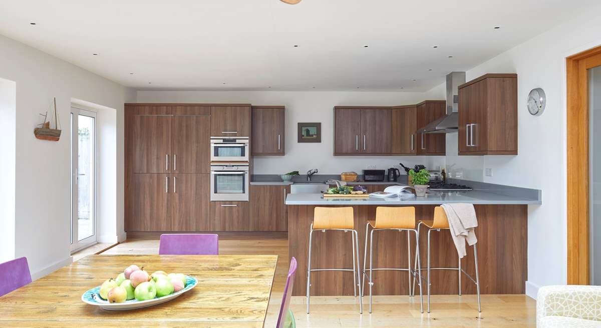 Chat with the chef at the breakfast-bar, or sit at the dining-table with a cuppa while watching the little ones play in the garden.