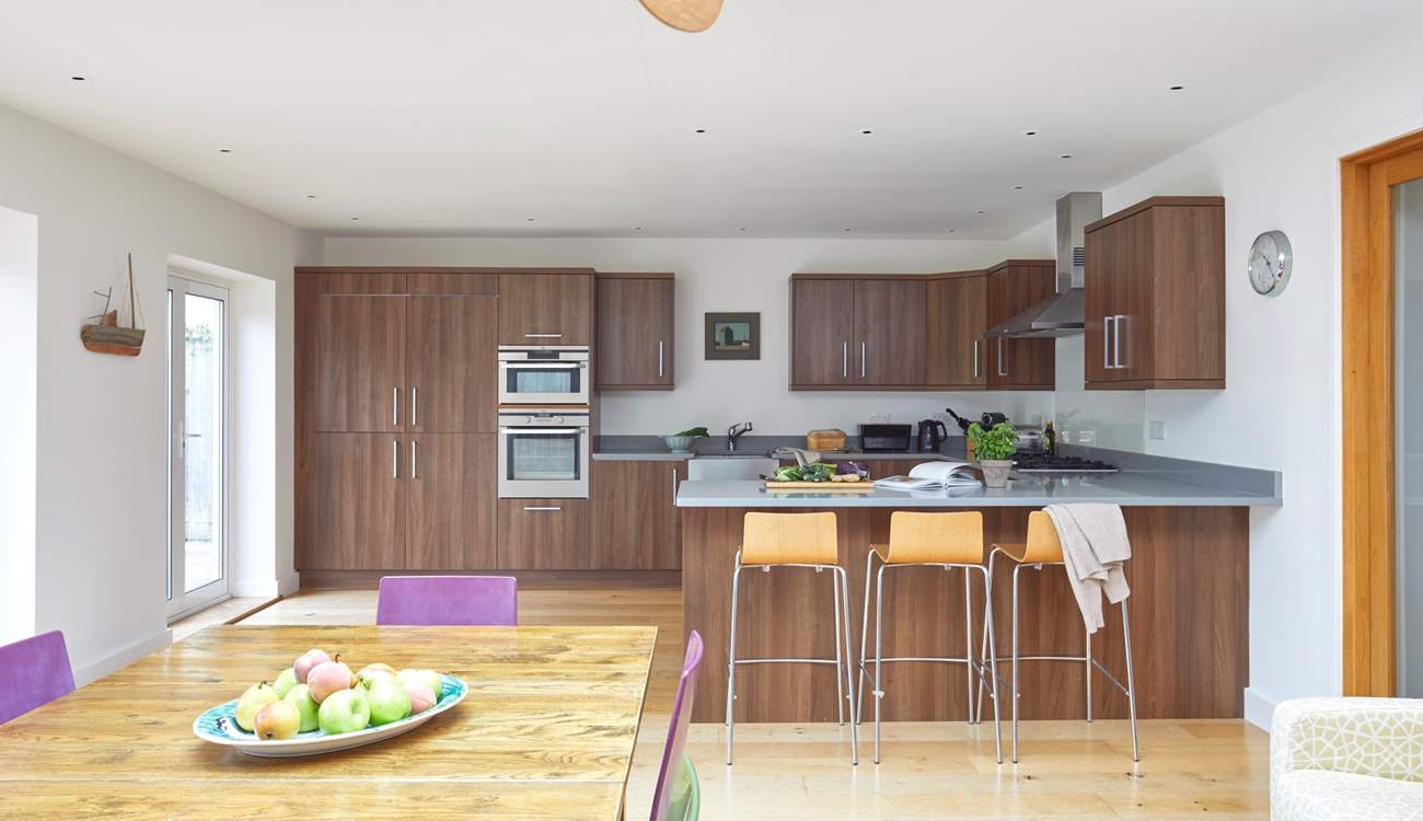 Chat with the chef at the breakfast-bar, or sit at the dining-table with a cuppa while watching the little ones play in the garden.