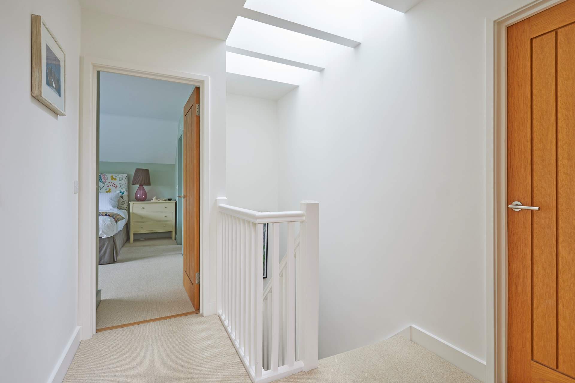 The first floor landing is light and airy thanks to the skylight.