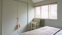 This stylish and generously sized bedroom overlooks the garden and has plenty of storage for all your clobber.