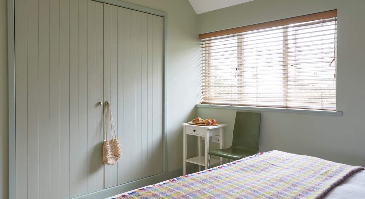 This stylish and generously sized bedroom overlooks the garden and has plenty of storage for all your holiday needs.