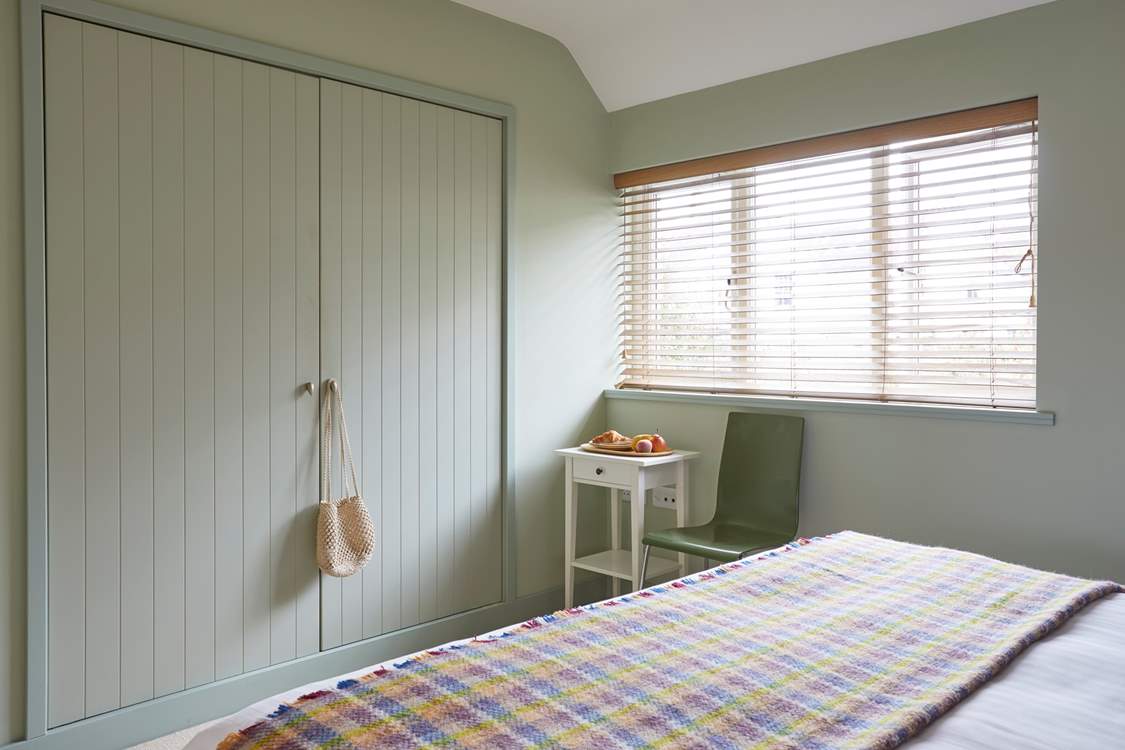 This stylish and generously sized bedroom overlooks the garden and has plenty of storage for all your holiday needs.