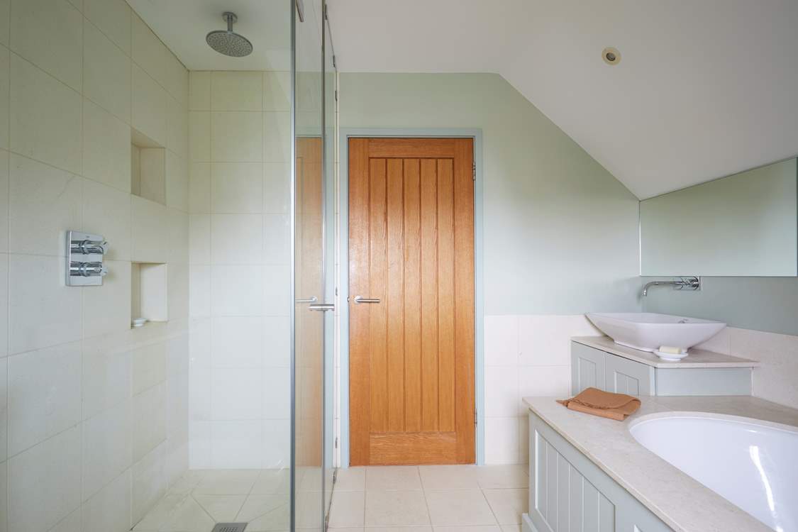 ...with separate shower. Please be aware of the sloping ceilings.