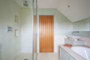 ...with separate shower. Please be aware of the sloping ceilings.