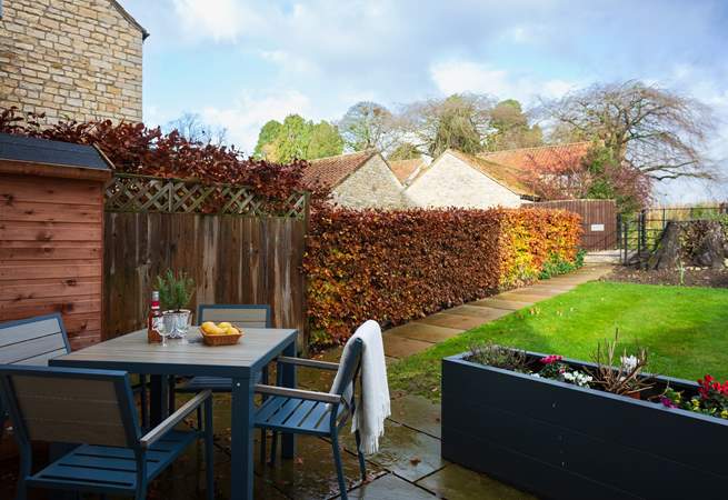 Enjoy a tipple in the pretty garden.