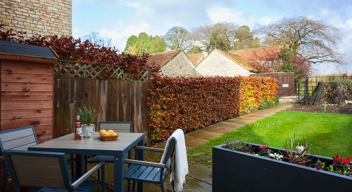 Enjoy a tipple in the pretty garden.