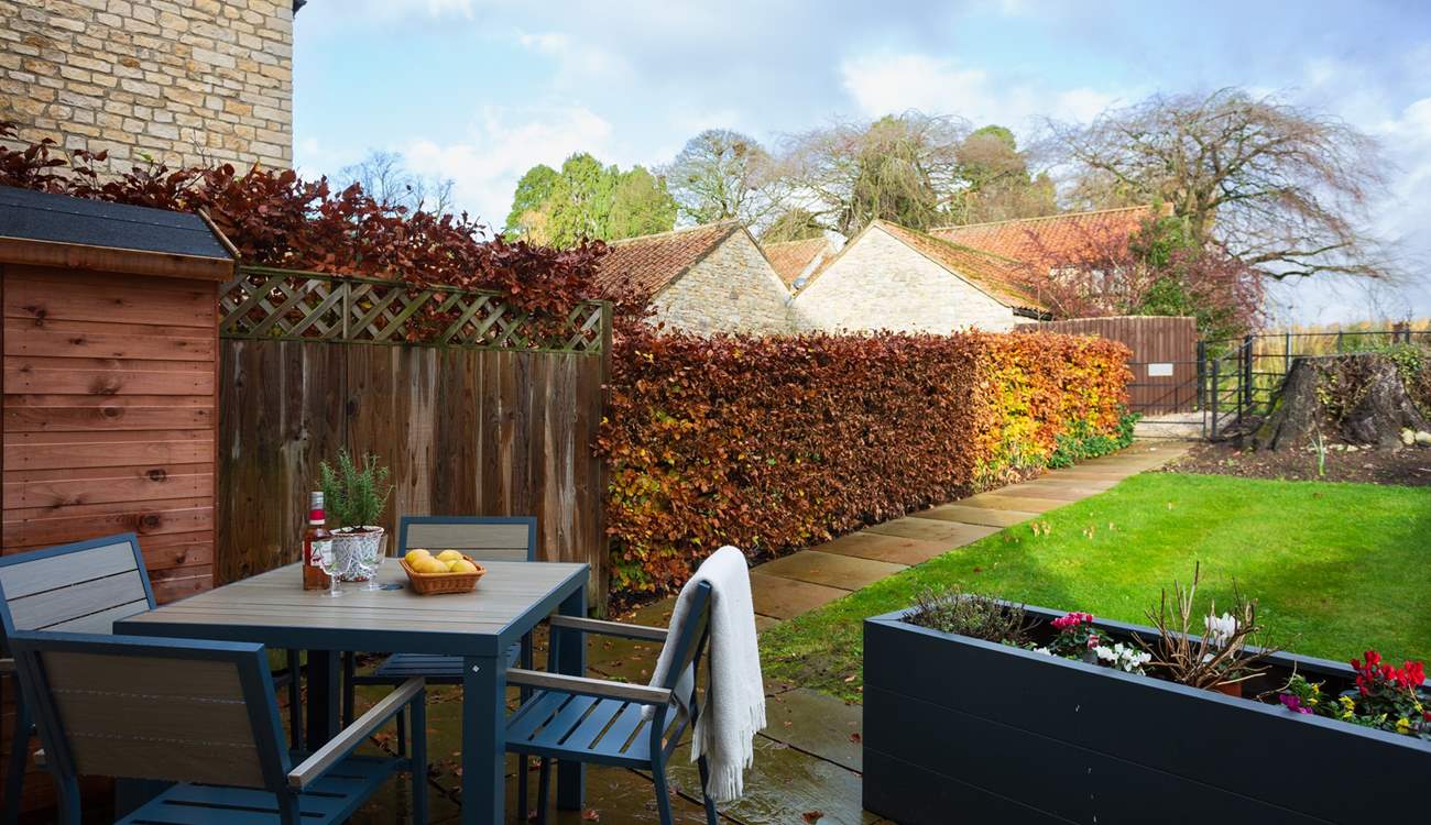 Enjoy a tipple in the pretty garden.